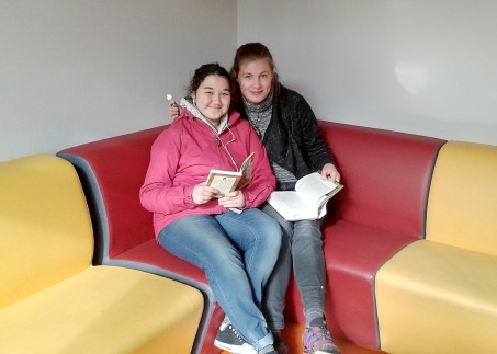 Zwei Schülerinnen lesen ein Buch im Leseclub